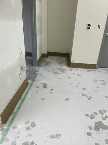 Epoxy cove base at a doorway threshold
