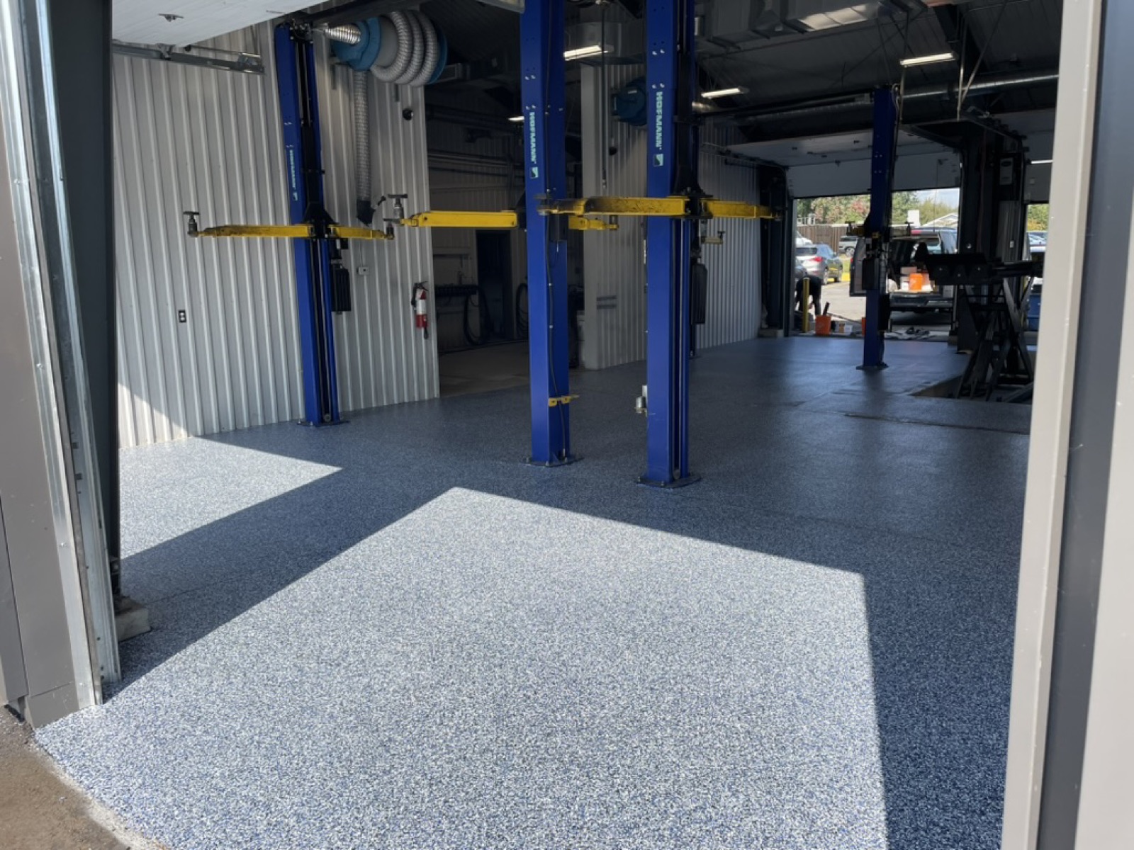 Blue epoxy flake finish in a commercial auto shop