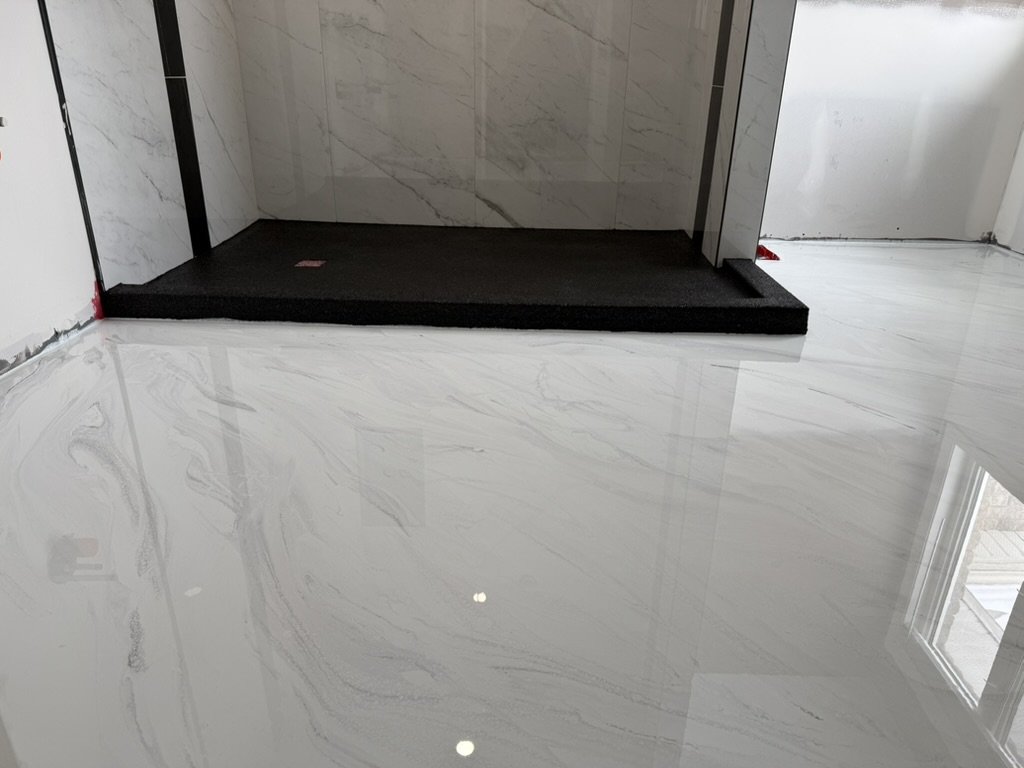 Marble epoxy bathroom floor matching shower tile