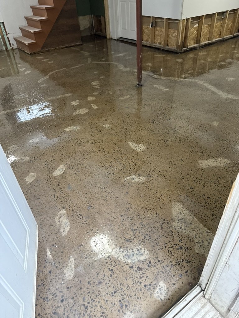 Unfinished basement floor before one coat epoxy