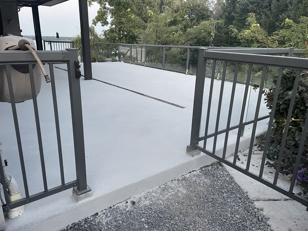 Gray quartz epoxy deck with glass railing