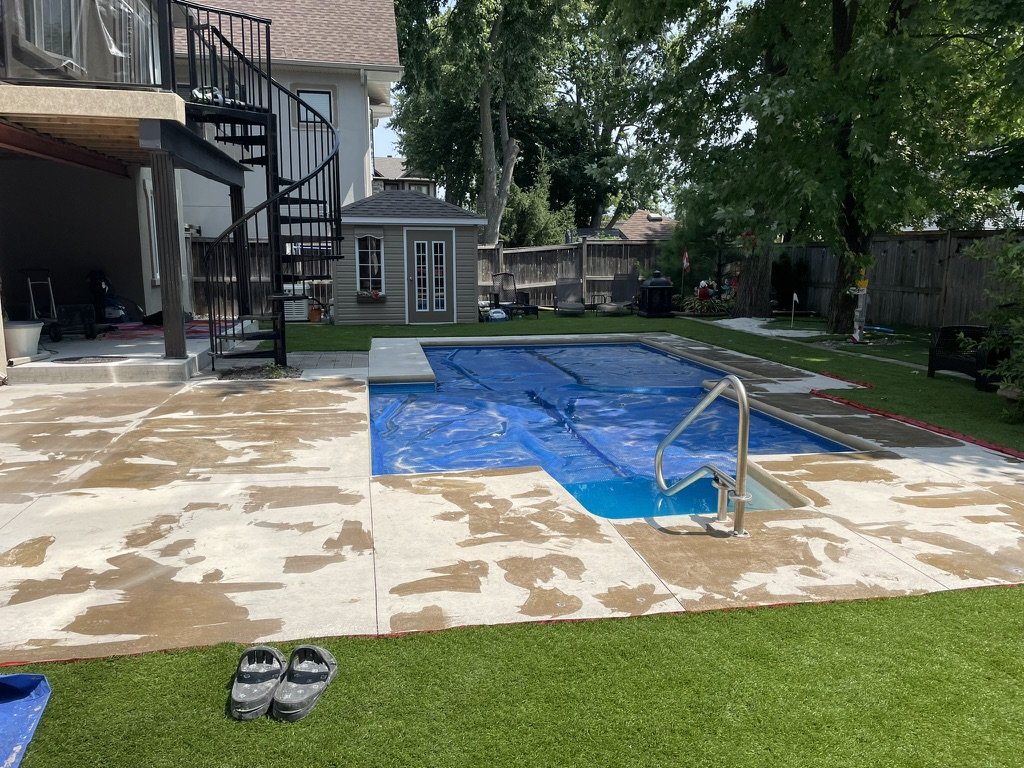 Bare concrete pool deck before quartz epoxy